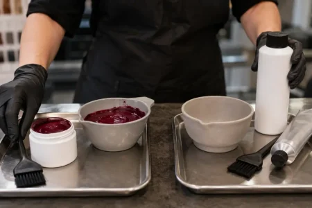 Colorist keeping semi-permanent and permanent hair dye products in separate bowls at a salon workstation